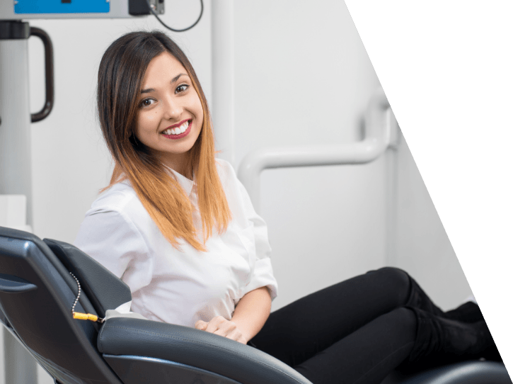 Woman smiling in dental treatment room