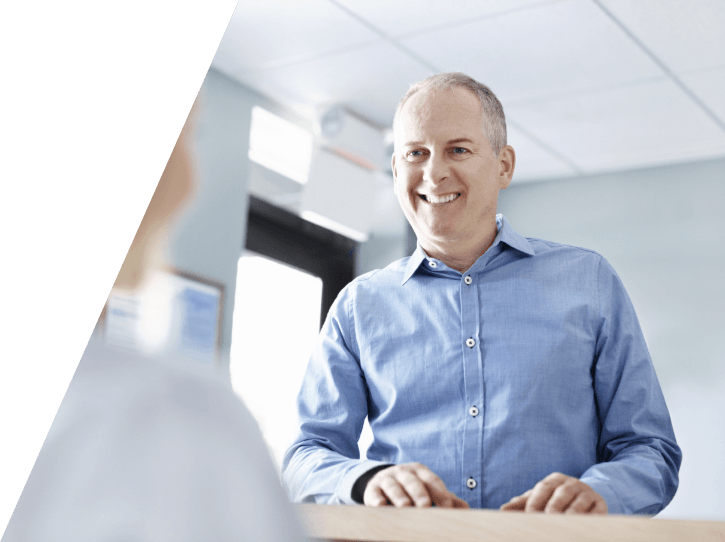 Dental patient checking in at dental office reception desk