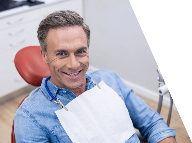 Man in dental chair smiling