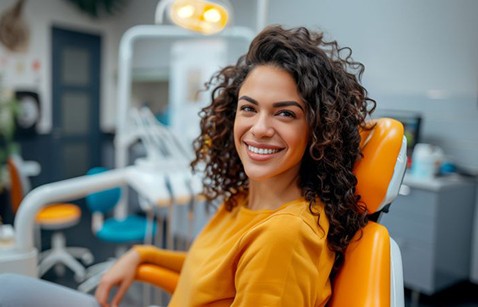Happy dental patient wearing orange top