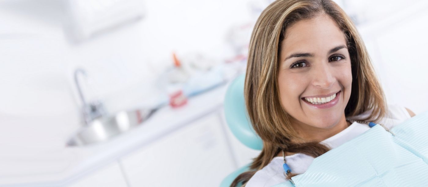 Woman smiling after comprehensive dental services