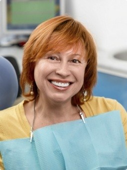 Woman sharing healthy smile after preventive dentistry treatment