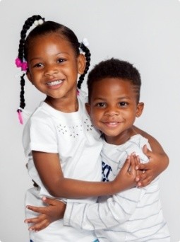 Two kids smiling after children's dentistry visit