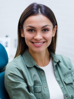Woman smiling after restorative dentistry treatment