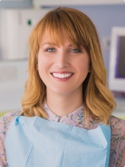 Woman smiling after emergency dentistry