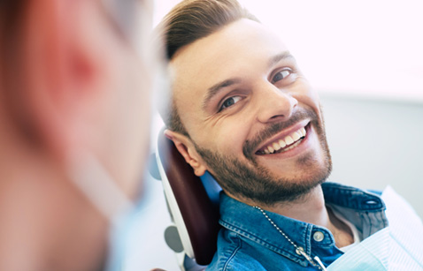 Man smiling at dentist in treatment chair