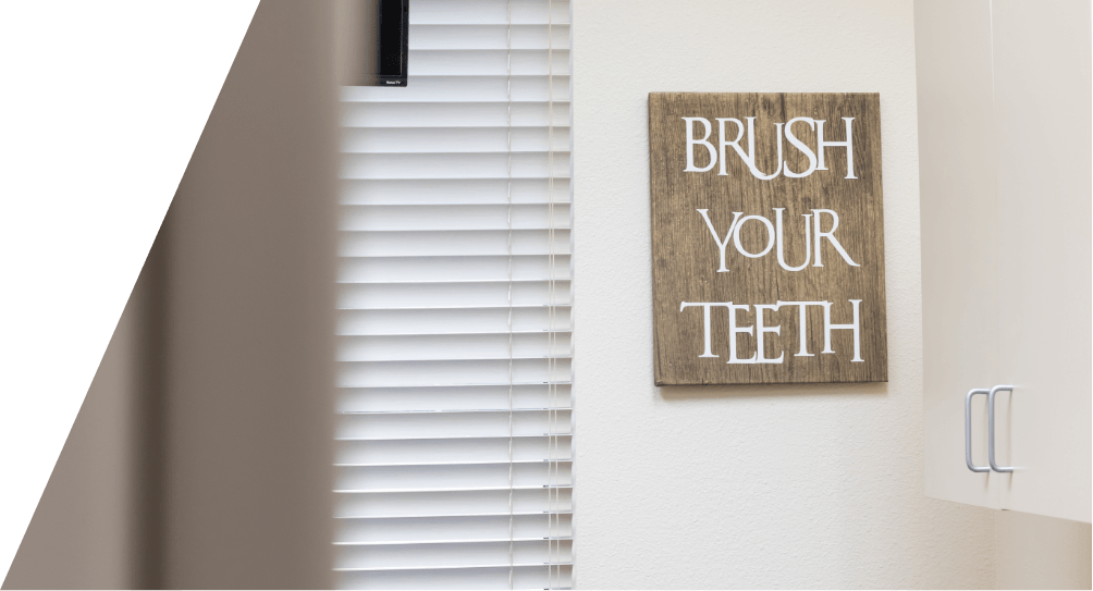 Brush your teeth sign hanging on dental office wall