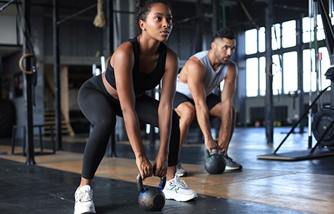 Man and woman working out in gym