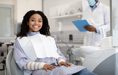 Woman smiling while sitting in treatment chair