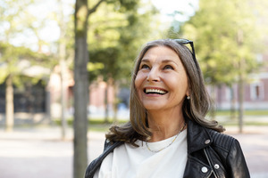 Senior woman with sunglasses smiling outside