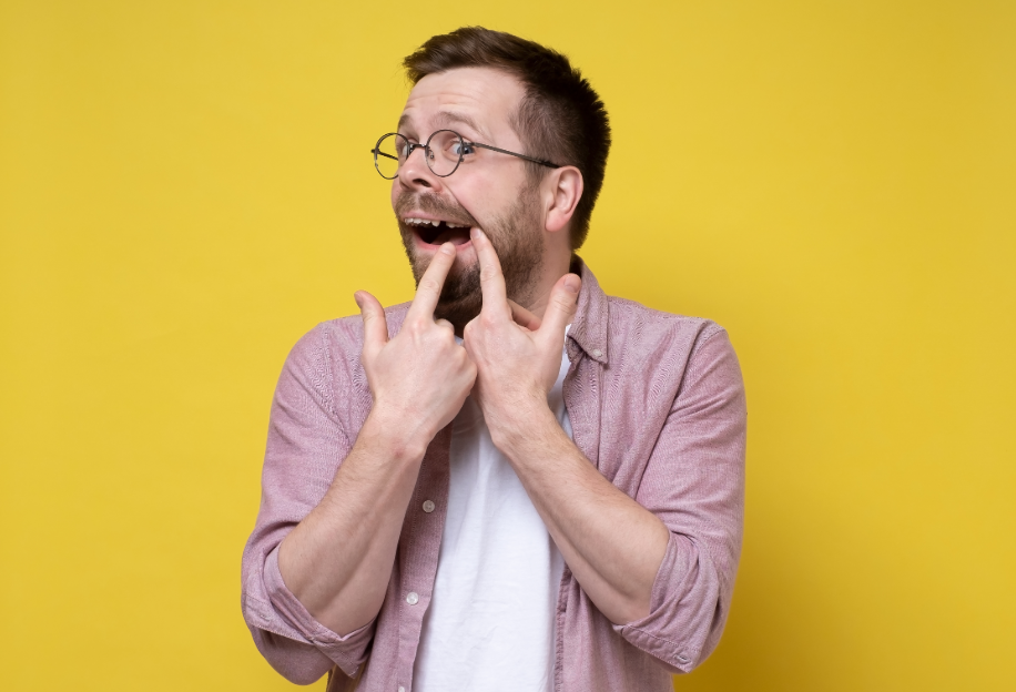 Man pointing at missing tooth